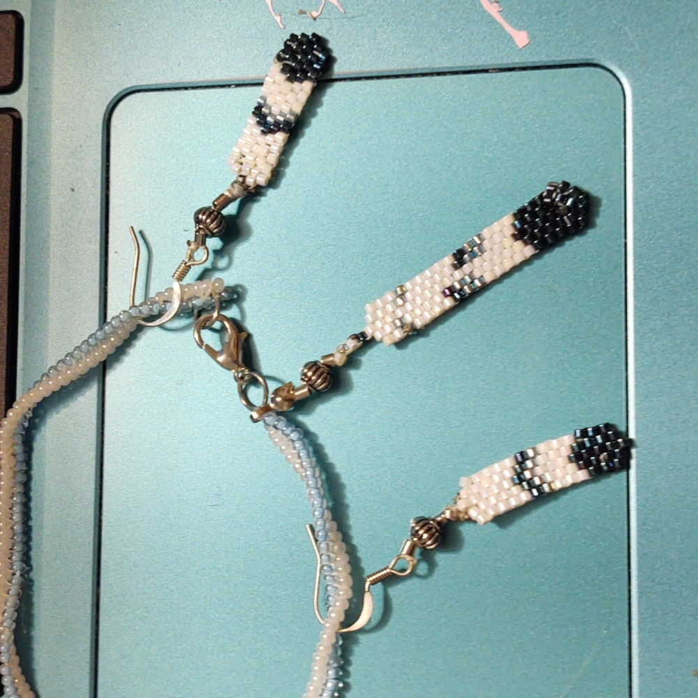 One of a kind. New. Beaded feather bracelet and earrings set